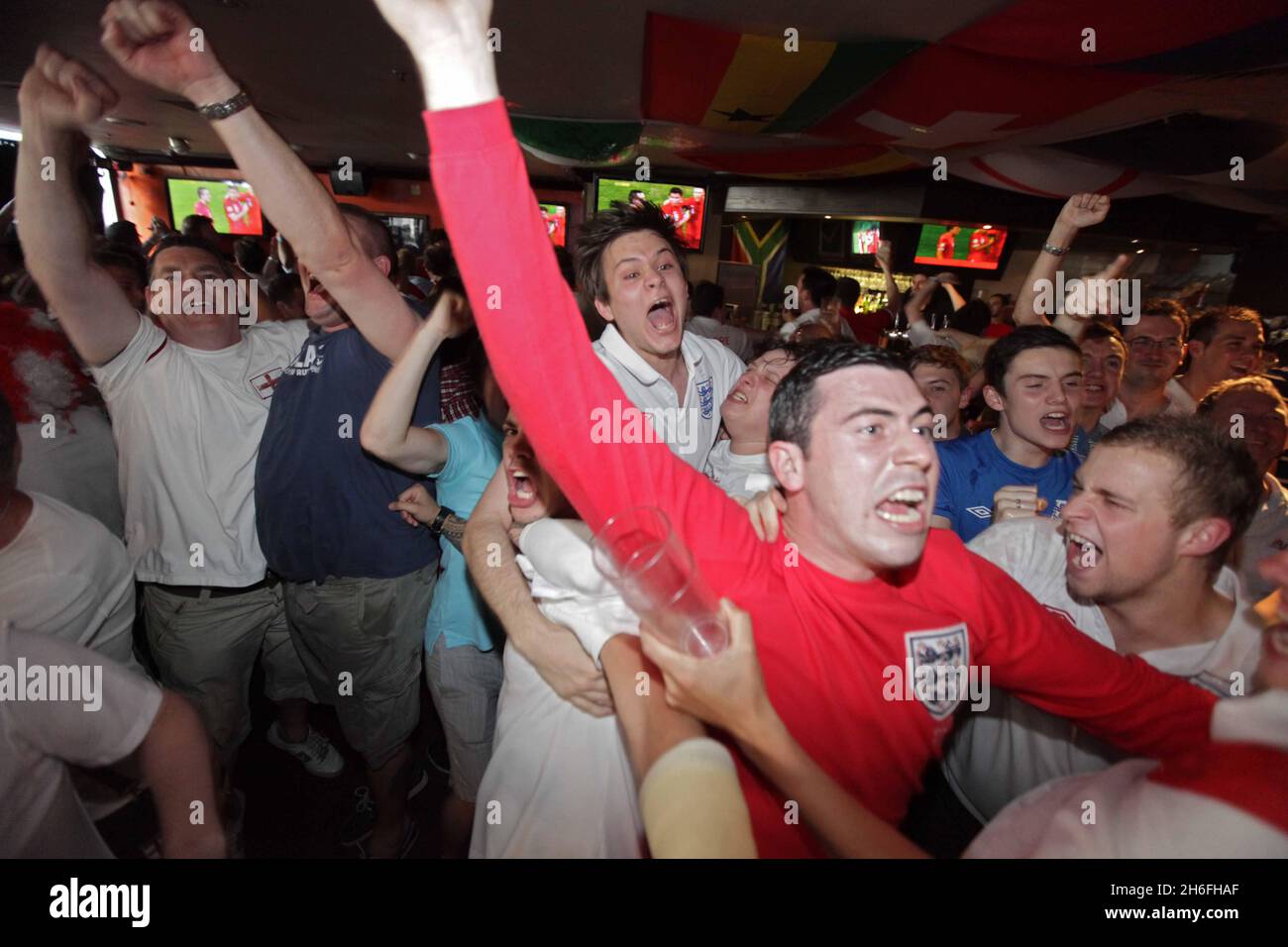 England football fans celebrate at The Sports Cafe in London's Haymarket this afternoon after England beat Slovenia in the World Cup Stock Photo