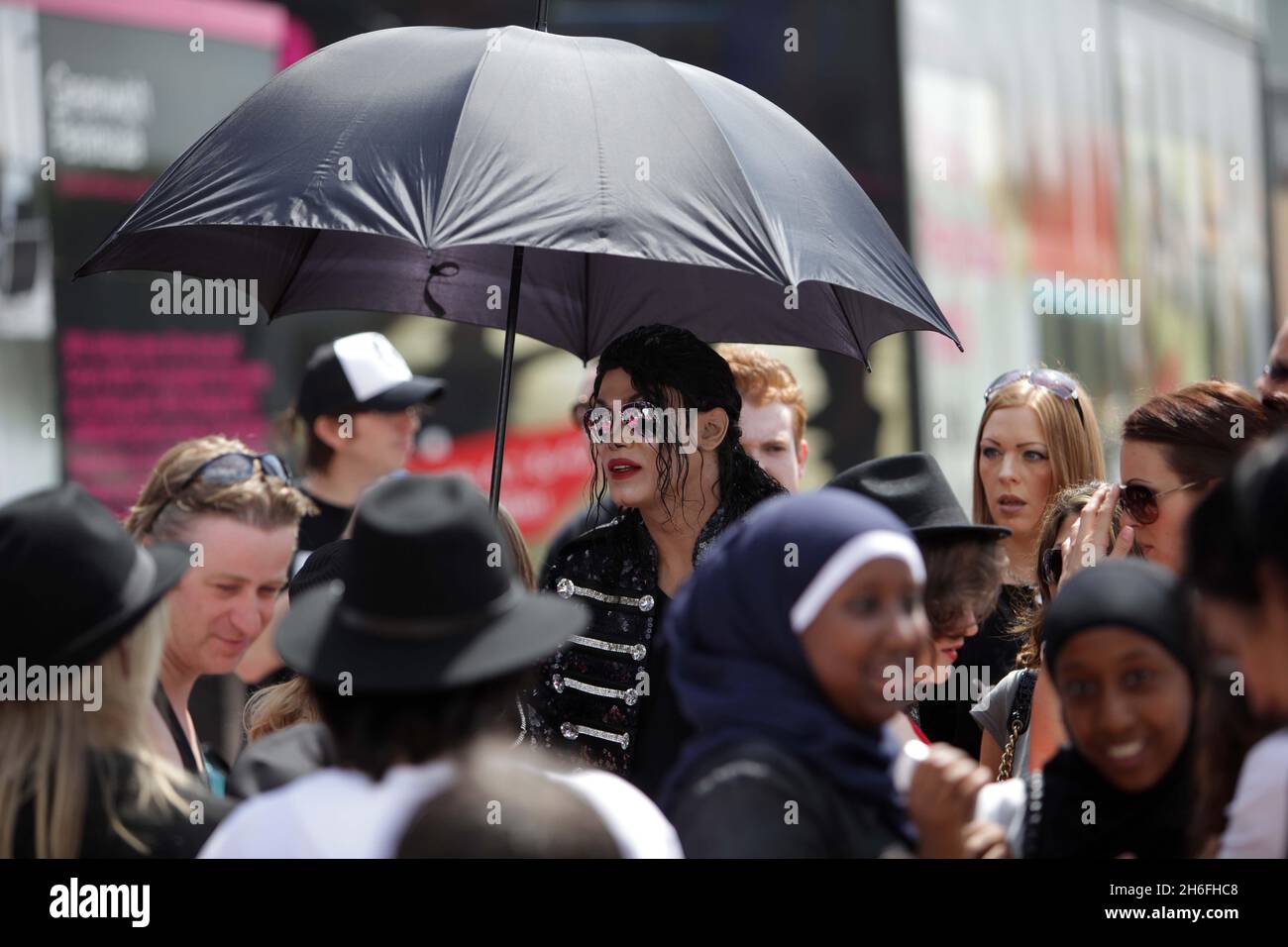 Michael Jackson fans gathered at the 02 arena in London today to mark the 1 year anniversary of the singers death. Jackson was preparing for a sold-out, 50-show residency at the arena before his sudden death. Picture shows: Navi, a Michael Jackson impersonator and tribute act, arriving at the arena Stock Photo
