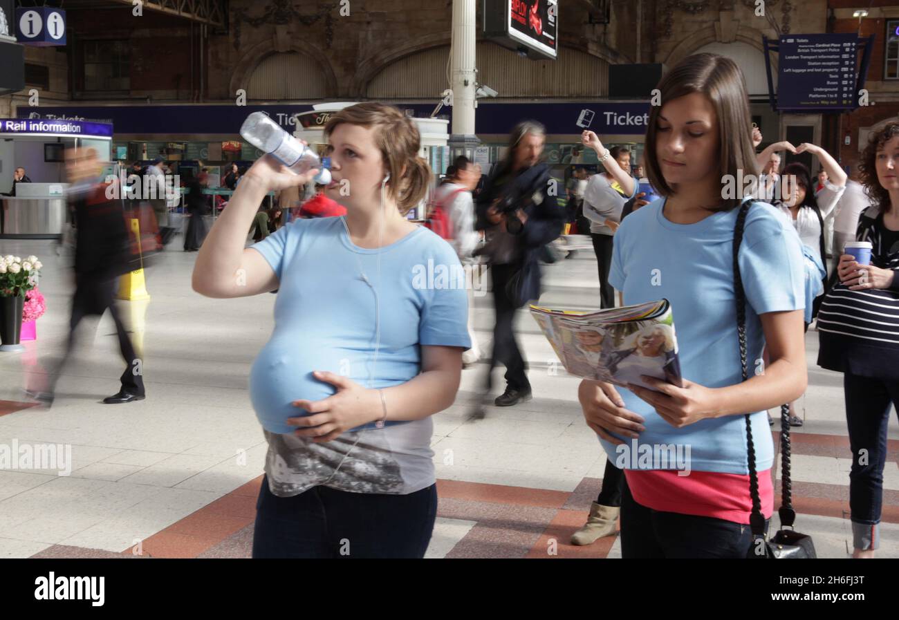 Over 75 Pregnant Pausers froze for nine minutes at Londons Victoria Station this morning to remind women to avoid alcohol while pregnant. The National Organisation on Fetal Alcohol Syndrome (NOFAS-UK) hosted the 2010 Pregnant Pause Flash Mob in London's Victoria Station with MP Toby Perkins and students from Chesterfield. At 9.09am on the ninth day of the ninth month every year, NOFAS-UK supporters freeze for nine minutes in a Pregnant Pause to warn of the dangers of drinking while pregnant. Stock Photo