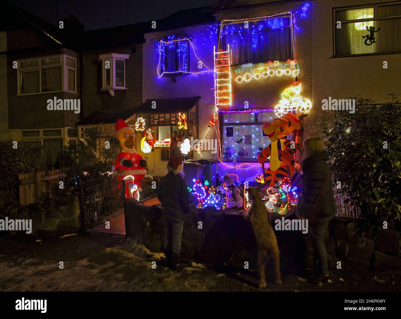 A house decorated with Christmas lights and an inflatable Homer Simpson and Tigger in East London, helps raise funds for Great Ormond Street Children's Hospital by receiving donations from onlookers. Stock Photo