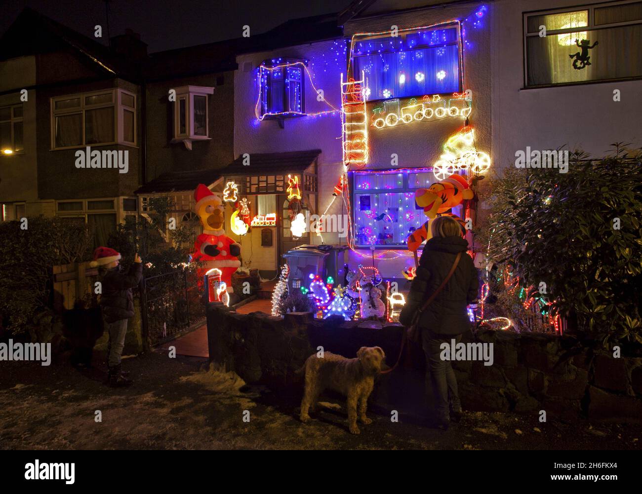 A house decorated with Christmas lights and an inflatable Homer Simpson and Tigger in East London, helps raise funds for Great Ormond Street Children's Hospital by receiving donations from onlookers. Stock Photo