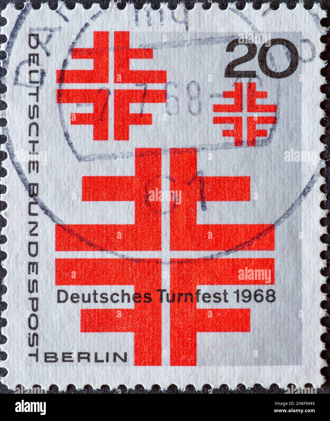 GERMANY, Berlin - CIRCA 1968: a postage stamp from Germany, Berlin showing red cross as a symbol of the German gymnast. Text: German Gymnastics Festiv Stock Photo