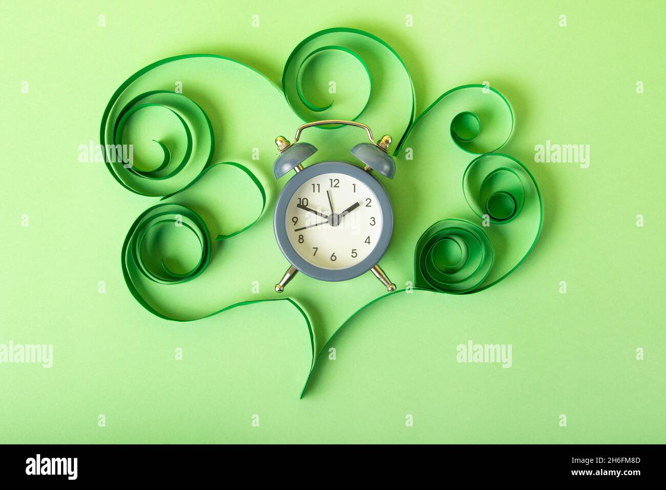 Human brain made from paper and alarm clock in it.COncept of the