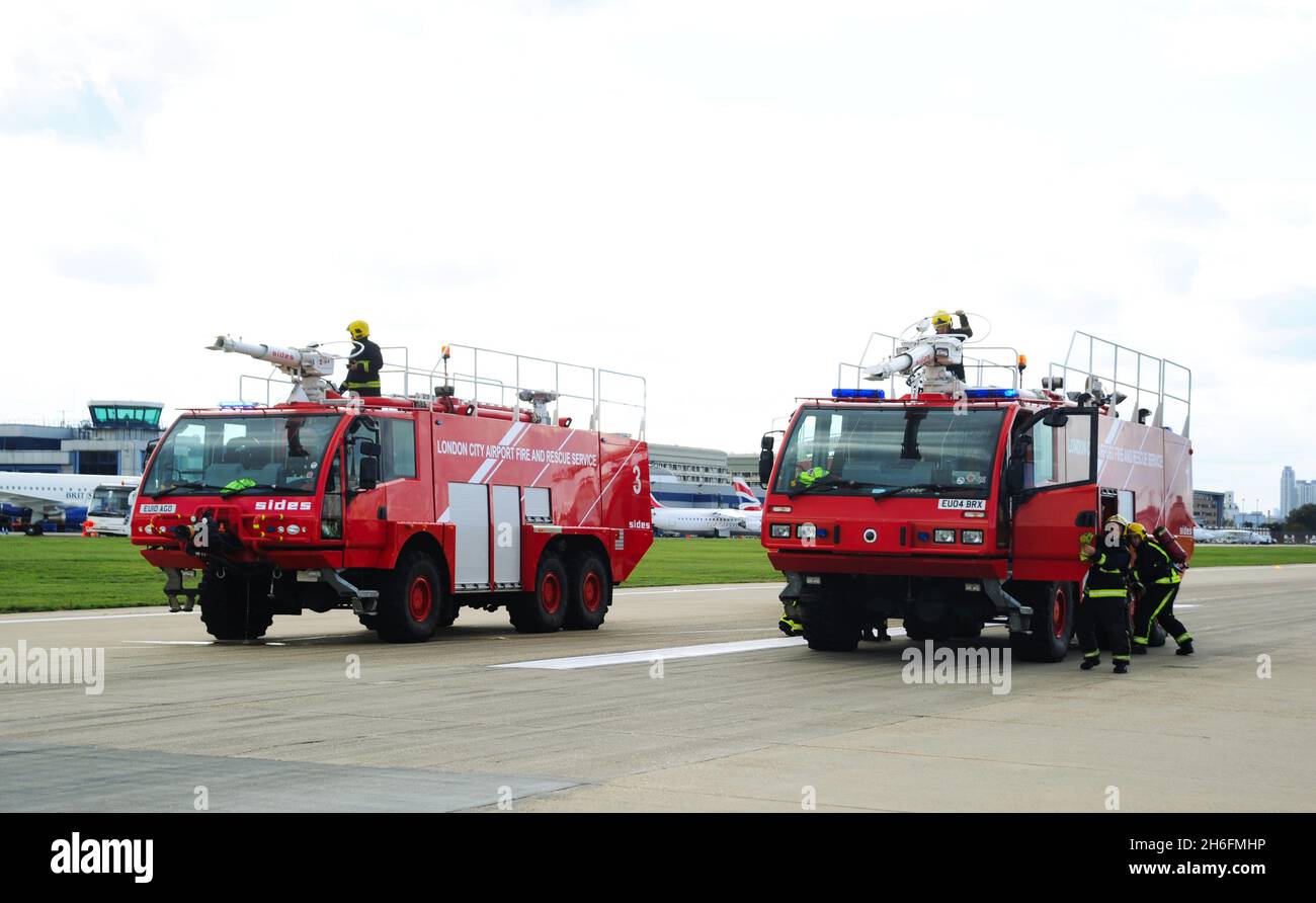 Fire Trucks at London City Airport. London City Airport is an international airport in London, England. It is located in the Royal Docks in the London Stock Photo