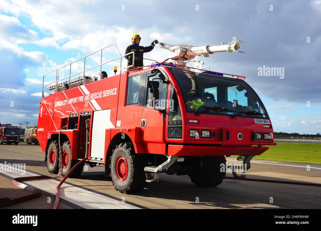 Fire Trucks at London City Airport. London City Airport is an international airport in London, England. It is located in the Royal Docks in the London Stock Photo