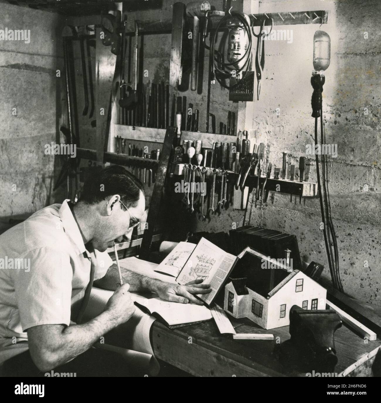 American student at home studying through a correspondence school for vocational training, USA 1954 Stock Photo