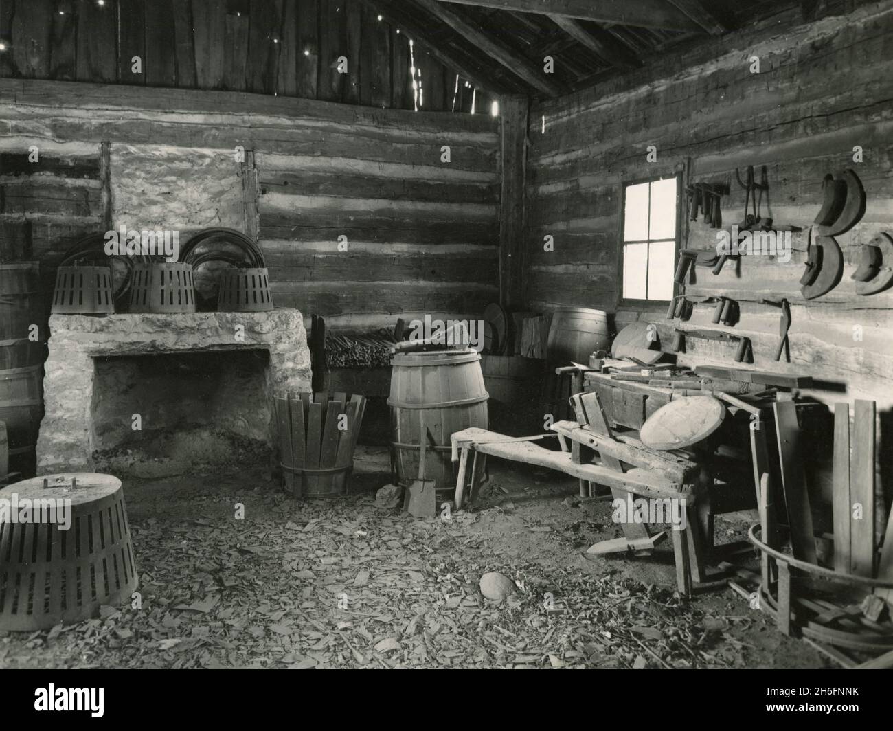 US President Abraham Lincoln studied by firelight in this New Salem cooper's shop, USA 1958 Stock Photo
