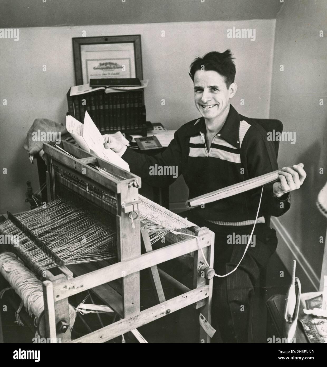 Technician John Campbell uses a hand loom for weaving experimental