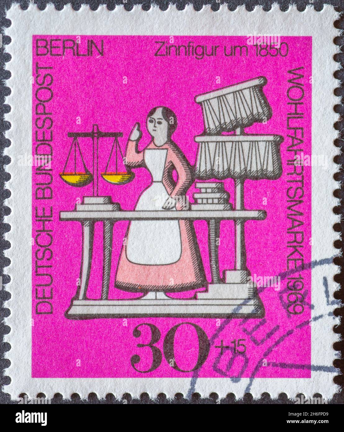 GERMANY, Berlin - CIRCA 1969: a postage stamp from Germany, Berlin showing a charity postal stamp from 1969 with a saleswoman in an antique shop as a Stock Photo