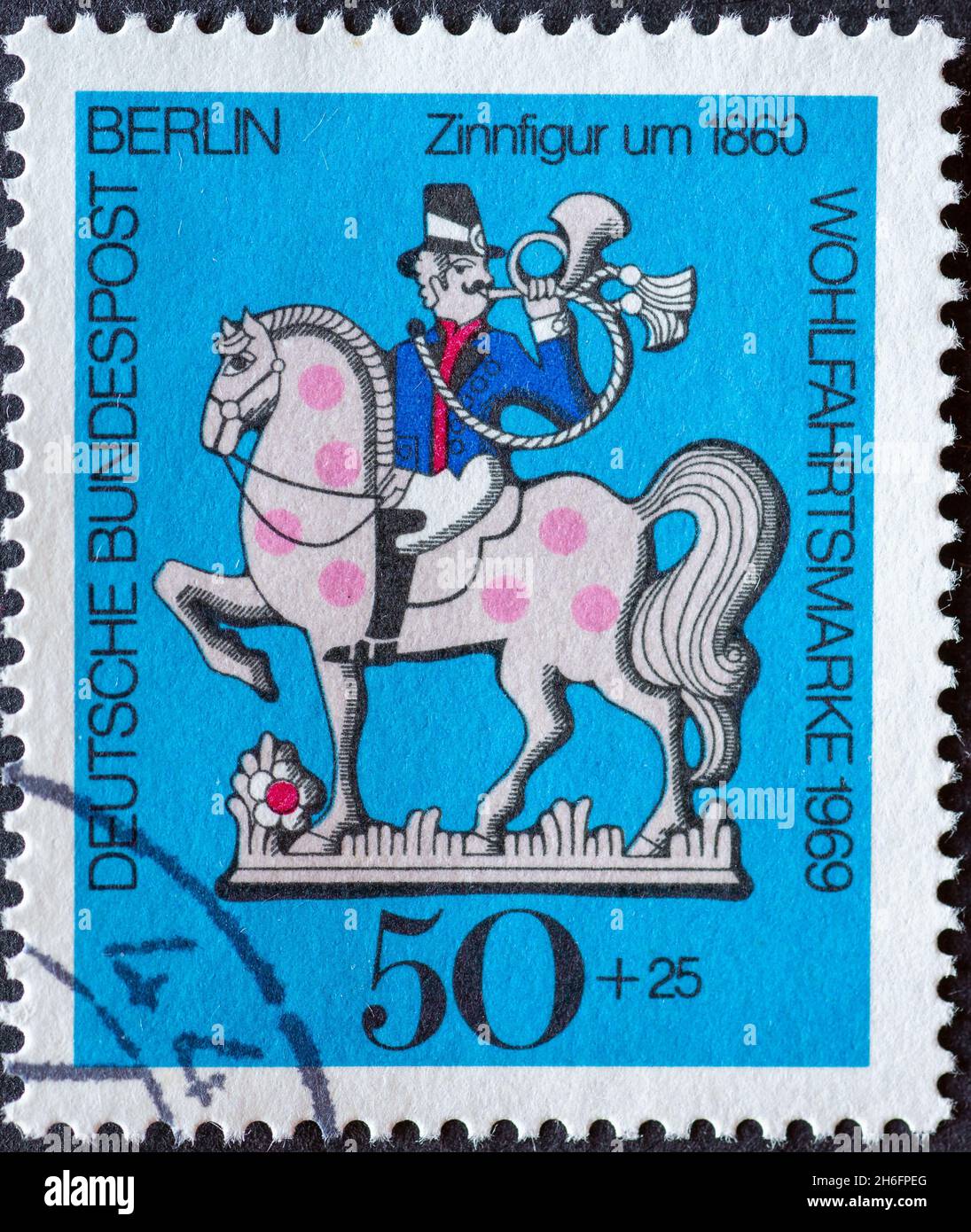 GERMANY, Berlin - CIRCA 1969: a postage stamp from Germany, Berlin showing a charity postal stamp from 1969 with Postilion on horse with horn as a tin Stock Photo