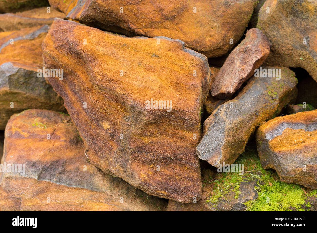 Iron stone sedimentary rock mineral deposits with iron ore (FE) used for smelting commercially to make iron metal. Banded silver to black red chert Stock Photo