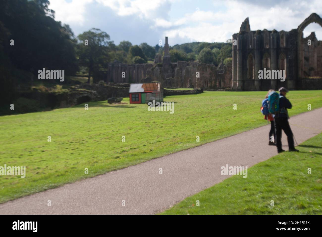 Visitors walking on path near twoer and Chapel of the Altars, Fountains