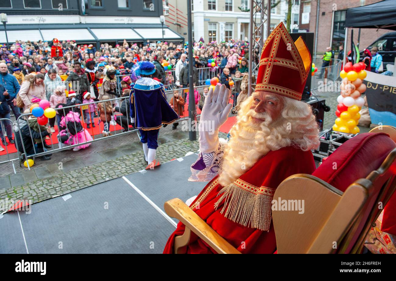 ENSCHEDE, THE NETHERLANDS - NOV 13, 2021: The dutch Santa Claus called 'Sinterklaas' is arriving in town. This year he is sitting on a chair in front Stock Photo