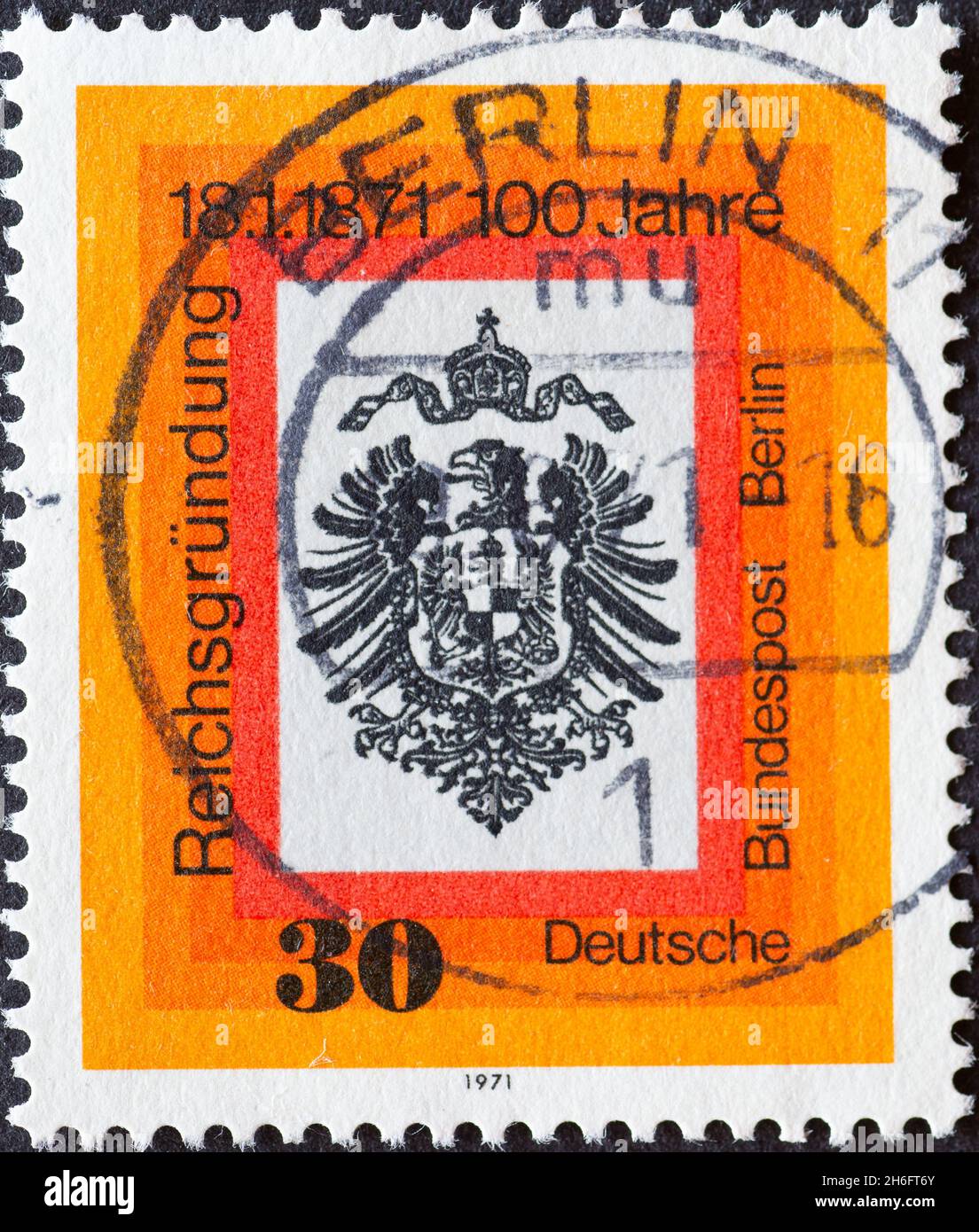 GERMANY, Berlin - CIRCA 1971: a postage stamp from Germany, Berlin showing an imperial eagle and imperial crown. Text 100 years of the founding of the Stock Photo