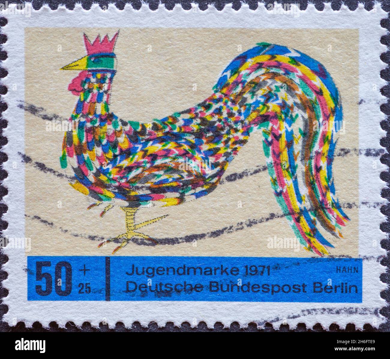 GERMANY, Berlin - CIRCA 1971 a postage stamp from Germany, Berlin showing a 1971 charity postal stamp with colorful pictures of children. Here: cock Stock Photo