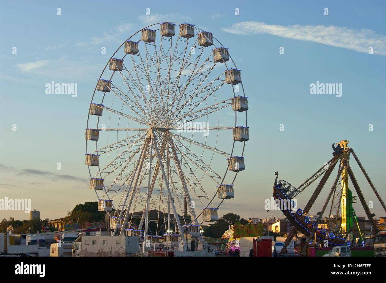 Ferris wheel and boat at sunset Stock Photo - Alamy