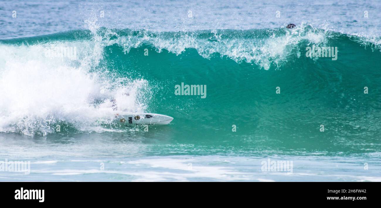 Surfer riding big blue waves Stock Photo - Alamy