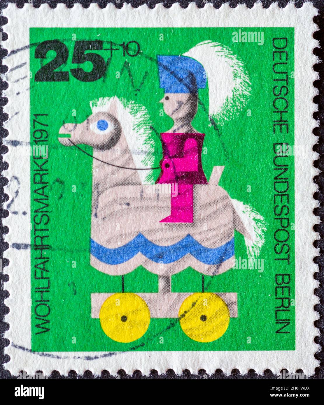 GERMANY, Berlin - CIRCA 1971: a postage stamp from Germany, Berlin showing a 1971 charity postal stamp with old wooden toys. Here: knight on horseback Stock Photo
