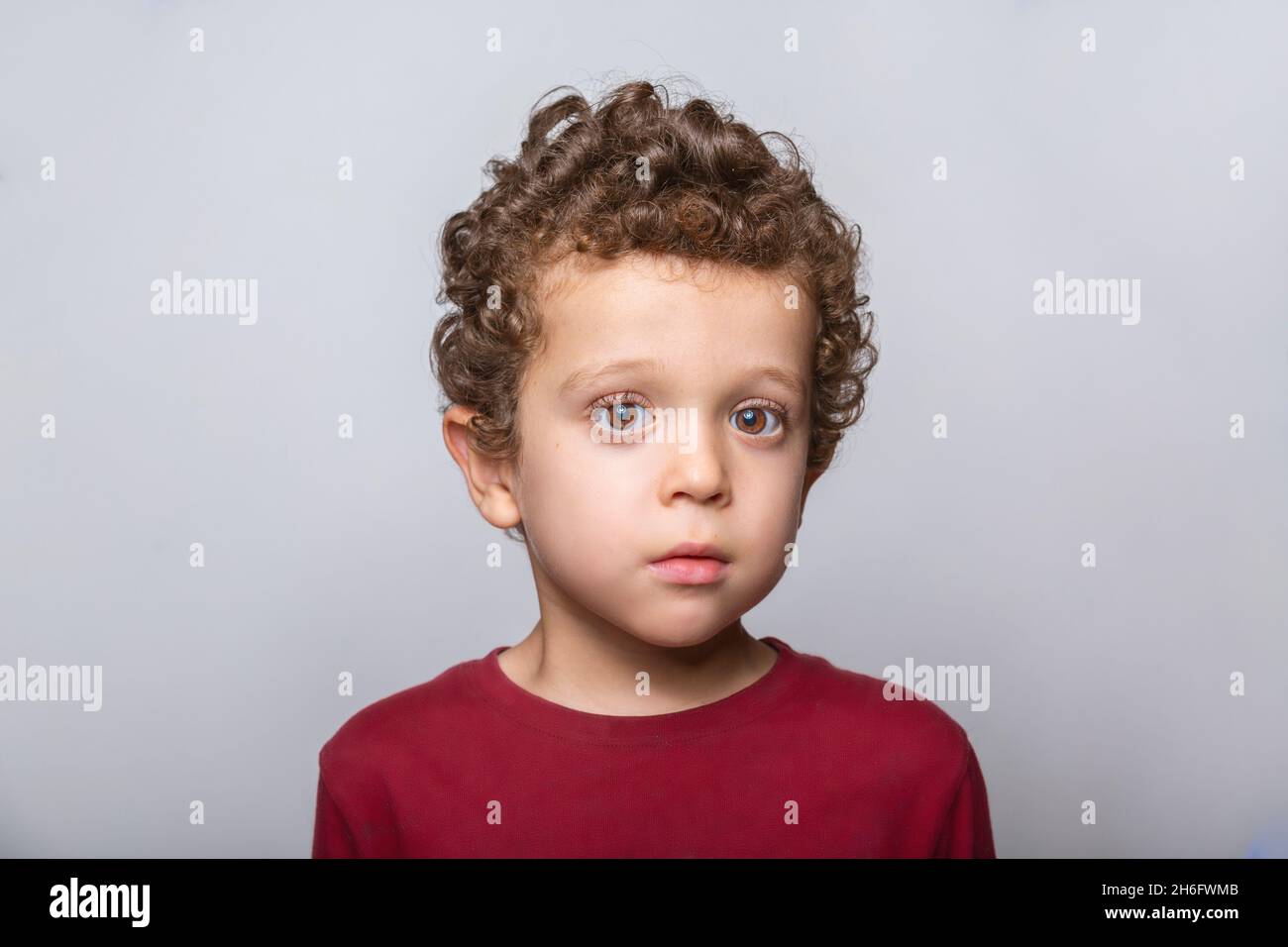 close-up of a beautiful Caucasian boy with curly hair Stock Photo