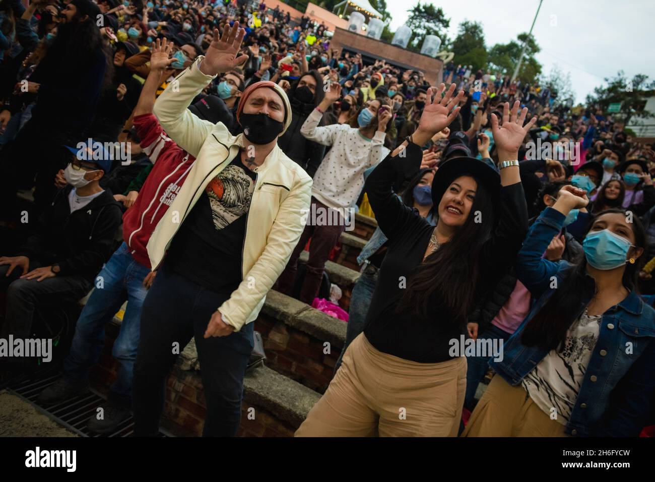 Concert goers enjoy the 2021 'Concierto Radionica 2021' were artists 'Velandia Y La Tigra, Briela Ojeda, Aterciopelados, Belgram and N Hardem, DJ Mike Style & Friends' the first concert with an occupation of a 100% amidst the aease of COVID-19 restrictions in Bogota, Colombia on November 13, 2021. Stock Photo