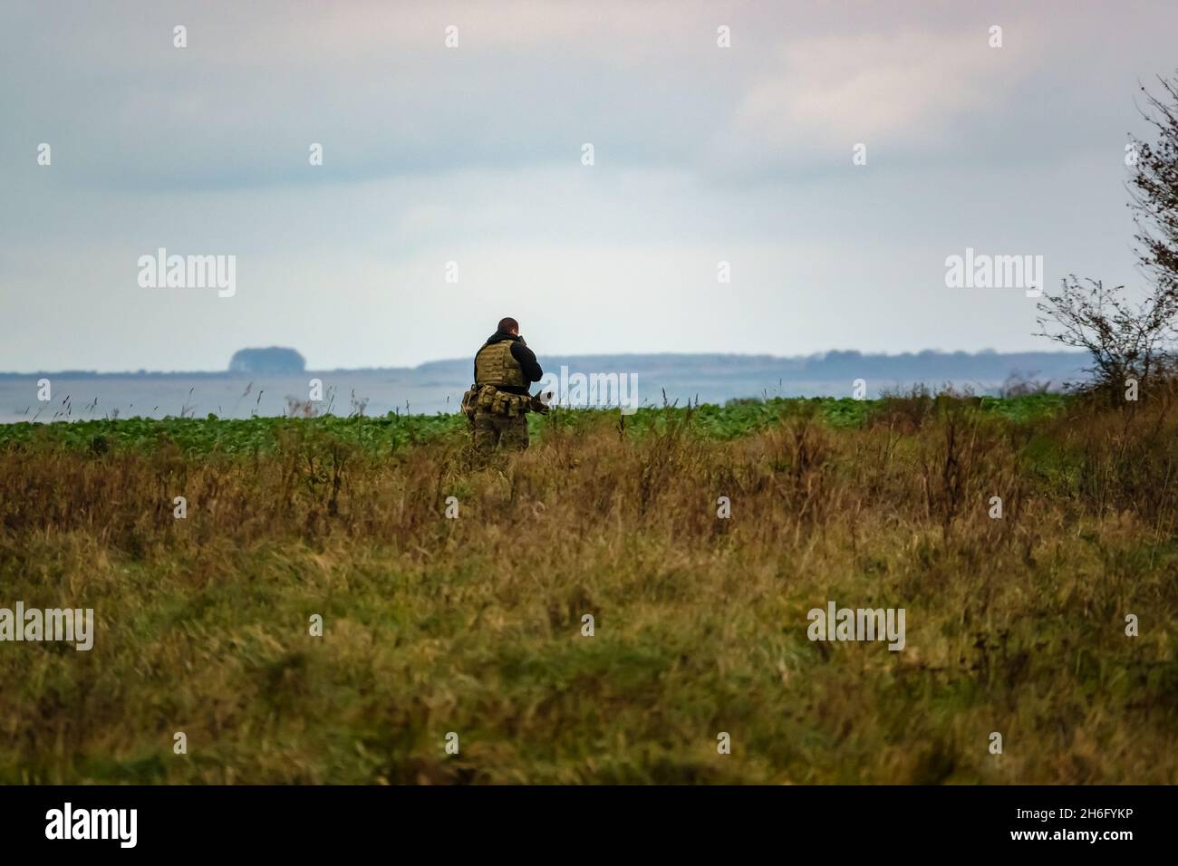 British army special forces soldier with SA80 L85 rifle at the ready runs towards enemy located in woodland, on a military exercise, Wiltshire UK Stock Photo