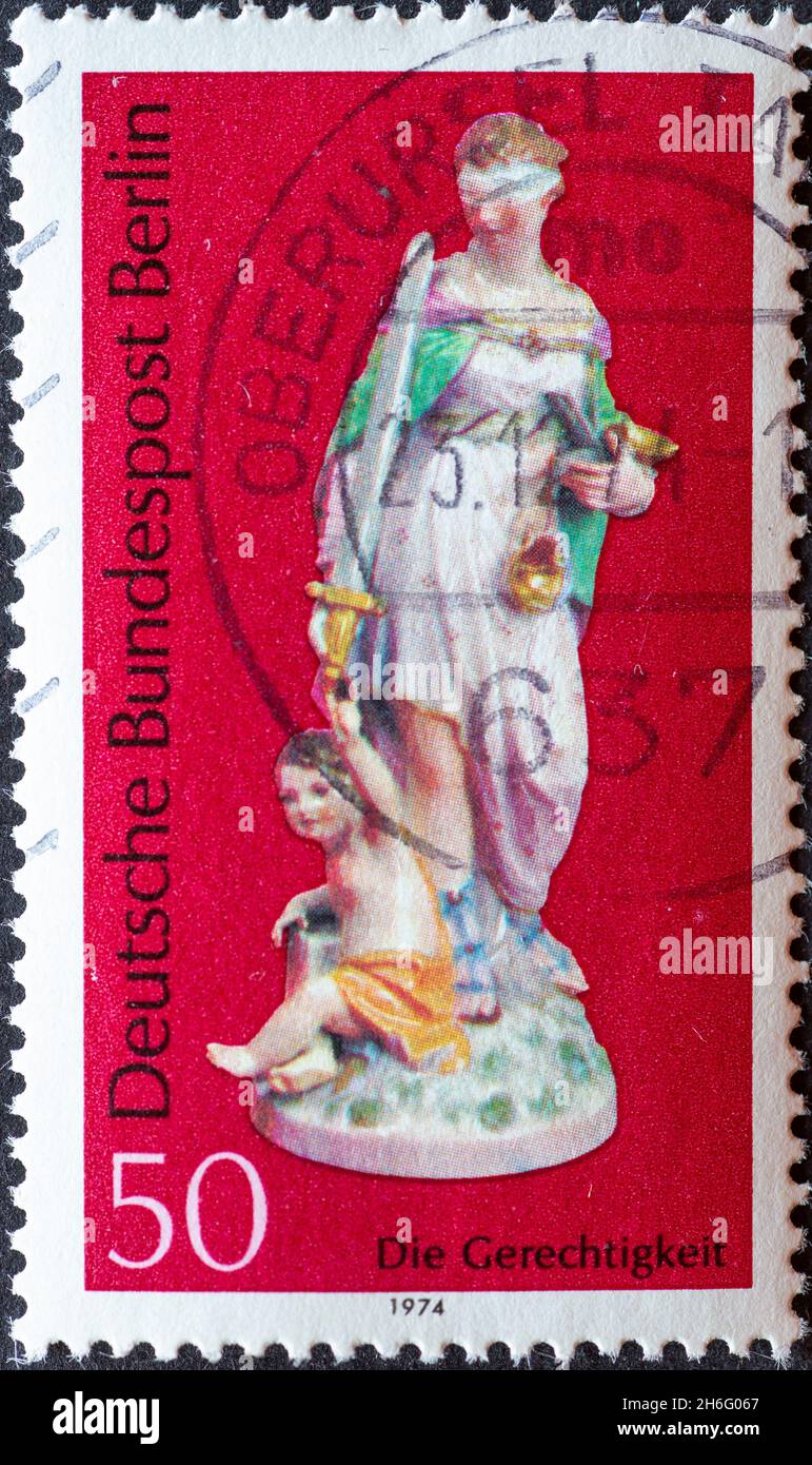 GERMANY, Berlin - CIRCA 1974: a postage stamp from Germany, Berlin showing a figure from Berlin porcelain:  justice Stock Photo