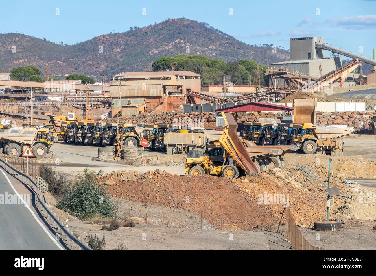 Huelva, Spain - November 13, 2021: Komatsu Mining trucks and other mining machinery in Corta Atalaya open mine pi in municipality of Minas de Riotinto Stock Photo