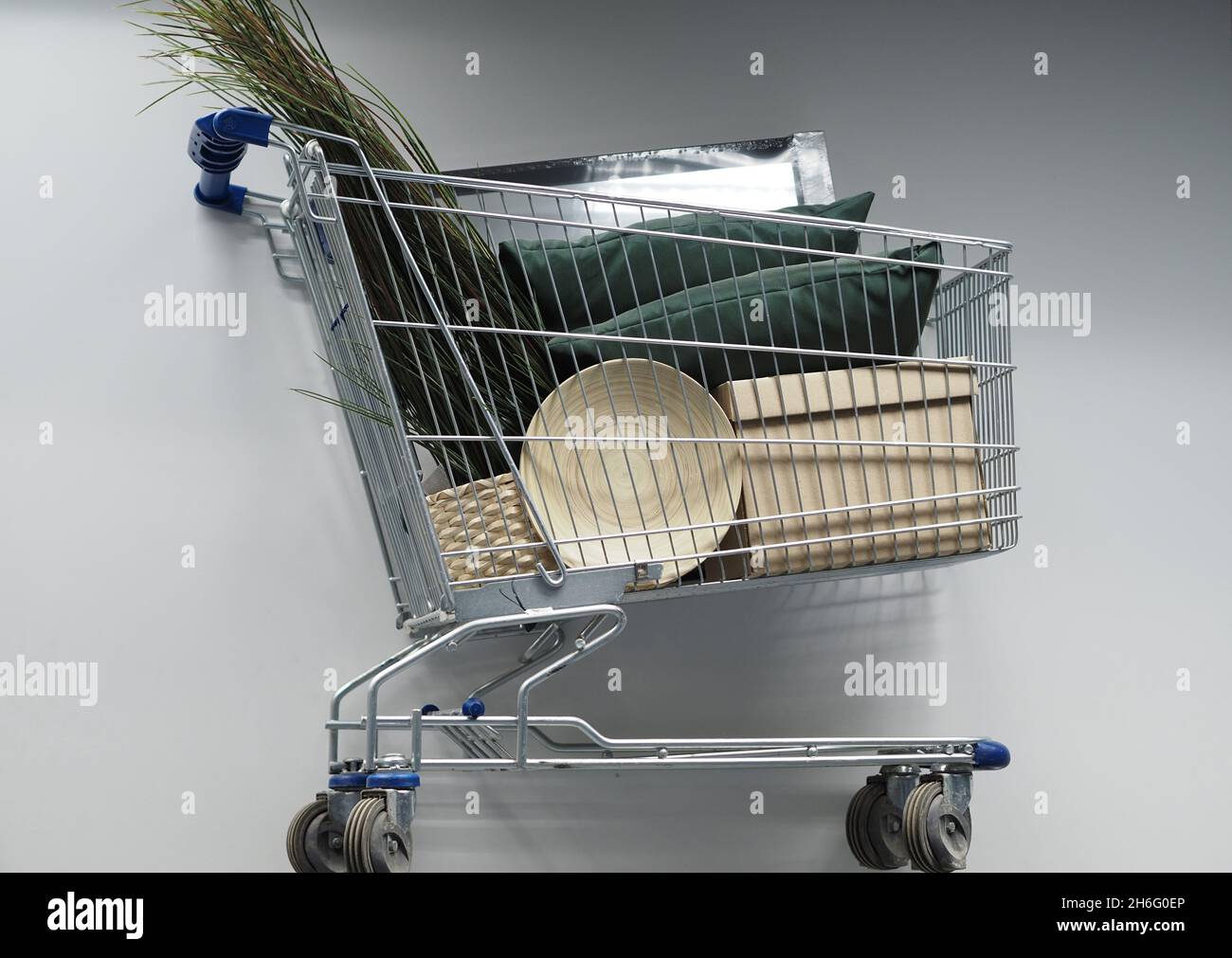 Shopping basket with goods in an industrial and household goods store. Stock Photo