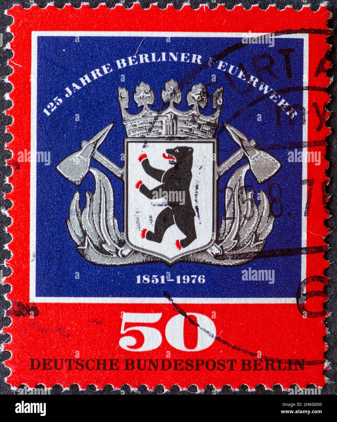GERMANY, Berlin - CIRCA 1976: a postage stamp from Germany, Berlin showing the Coat of arms of the Berlin fire department with Berlin bear and crossed Stock Photo