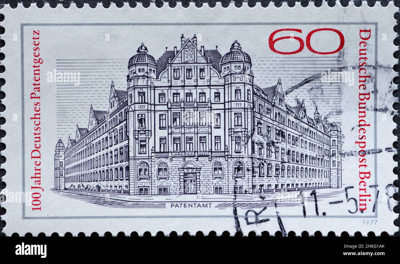 GERMANY, Berlin - CIRCA 1977: a postage stamp from Germany, Berlin showing the historic building of the patent office. Text: 100 years German patent l Stock Photo