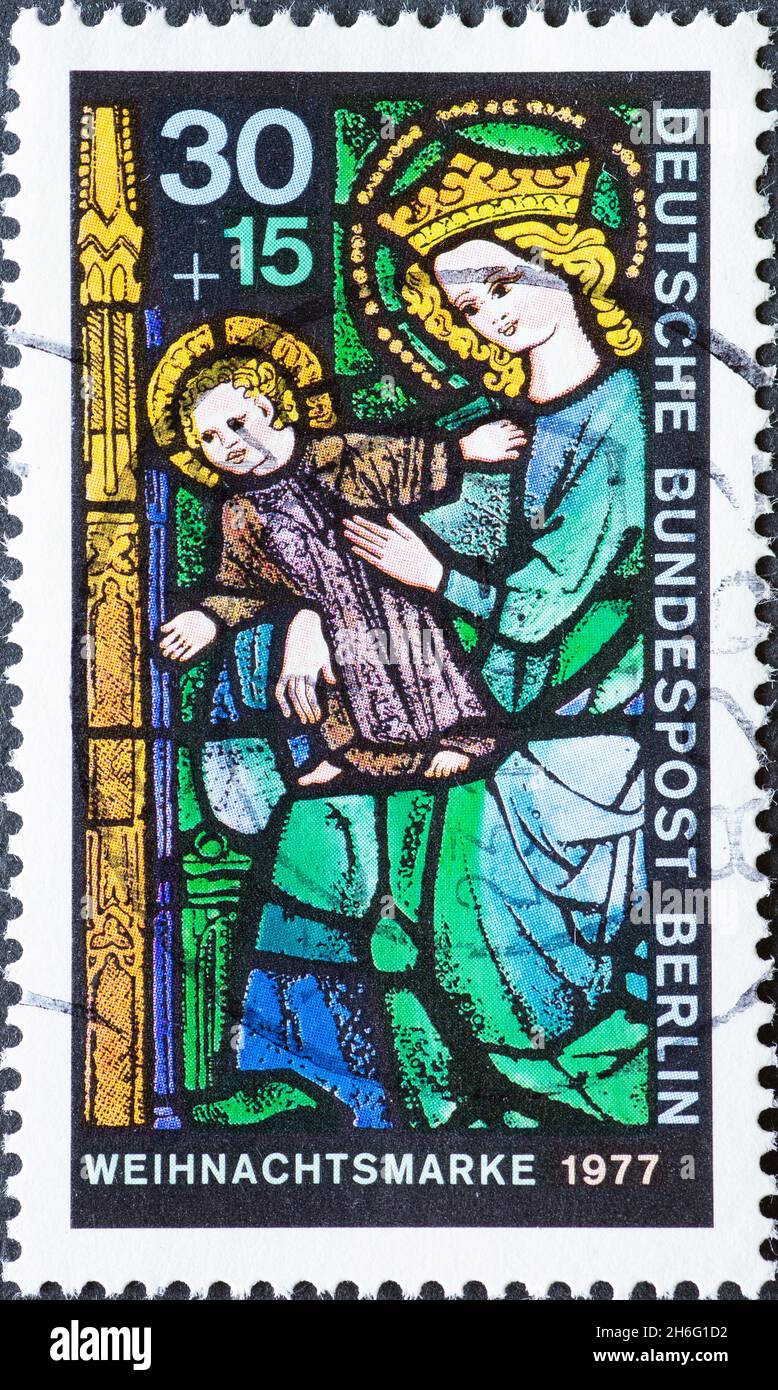 GERMANY, Berlin - CIRCA 1977: a postage stamp from Germany, Berlin showing the Christmas mask 1977. Lead stained glass. Mari and Christ Child Stock Photo