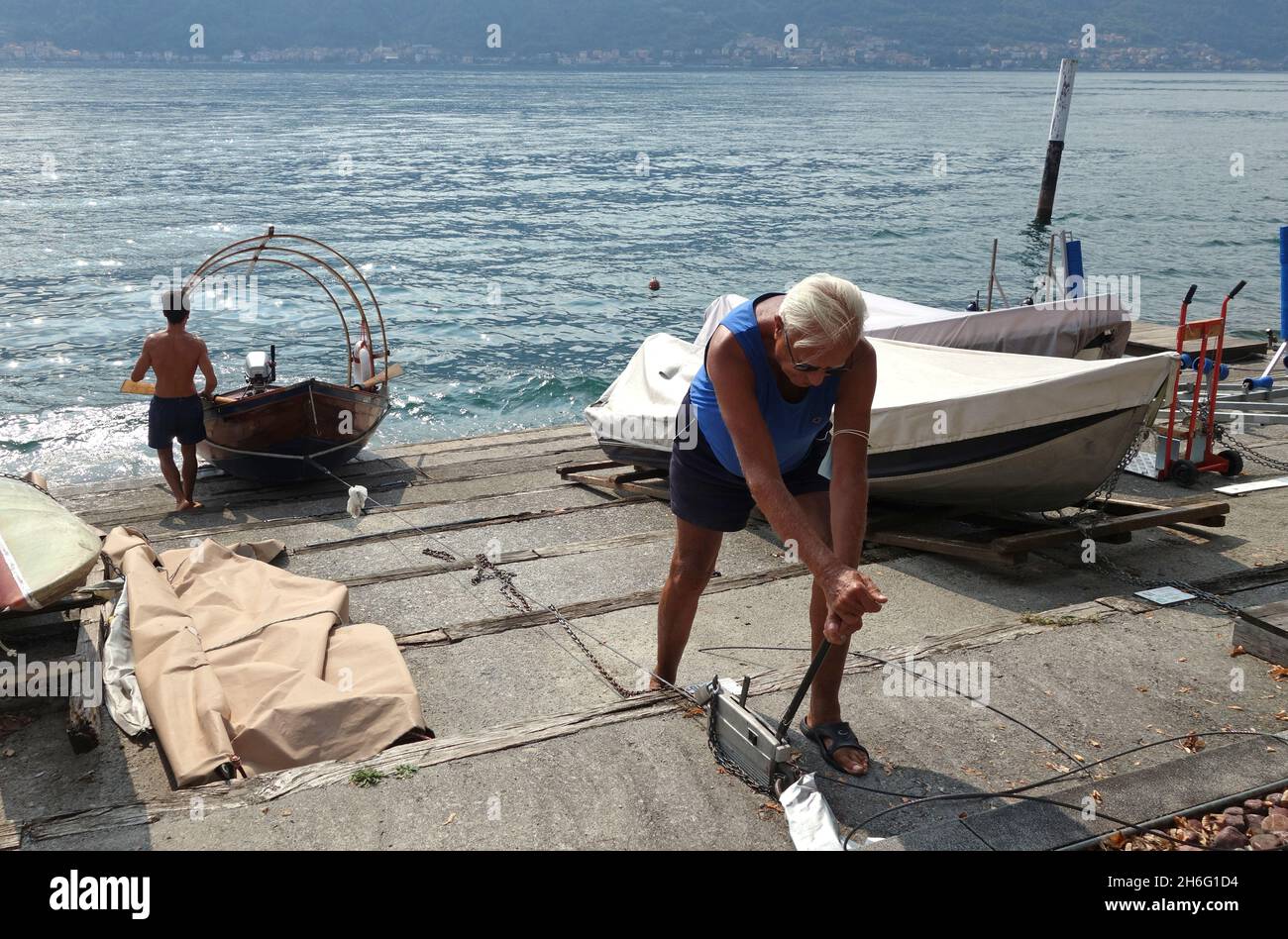 Man winching boat off Lake Como in Italy Stock Photo