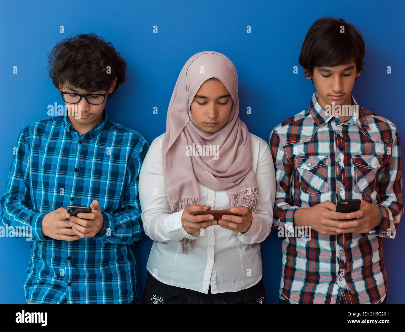arab teenagers group using smart phones for social media networking and ...