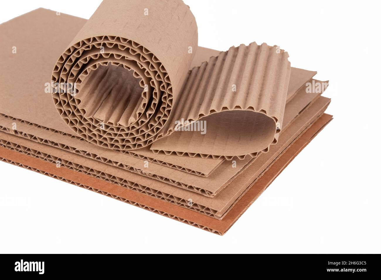 Corrugated cardboard layer pads and flexible singleface corrugated paper in  roll isolated on white. Environmentally friendly paper packaging Stock  Photo - Alamy