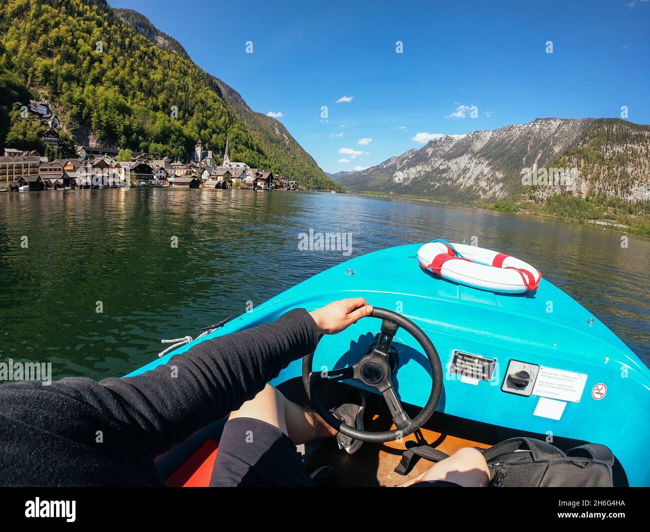 Man controls a motorboat on a mountain lake Stock Photo - Alamy