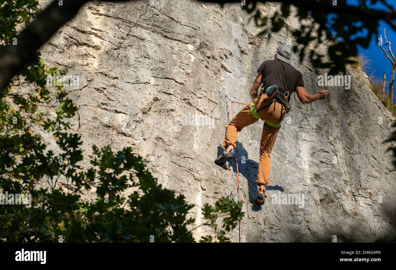 Rock climber climbing high mountains in Crni Kal Slovenia Stock Photo