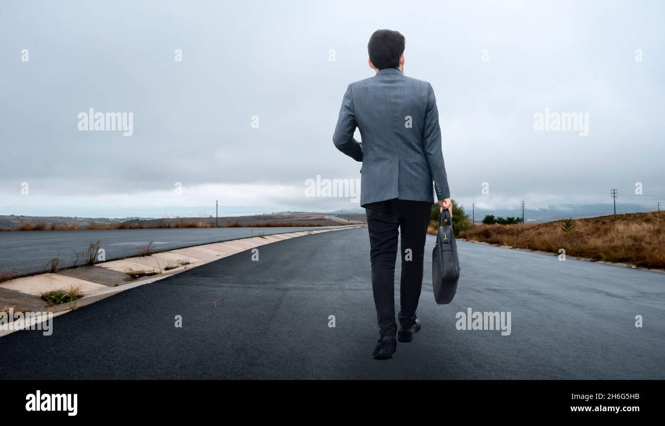 Young man walking empty road hi-res stock photography and images - Alamy