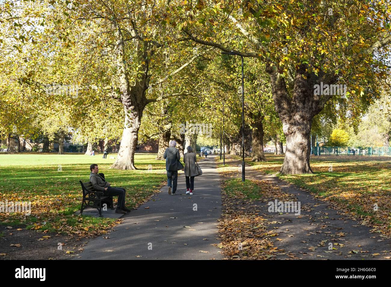 People enjoying sunny autumn day in London Fields park in Hackney, London England United Kingdom UK Stock Photo