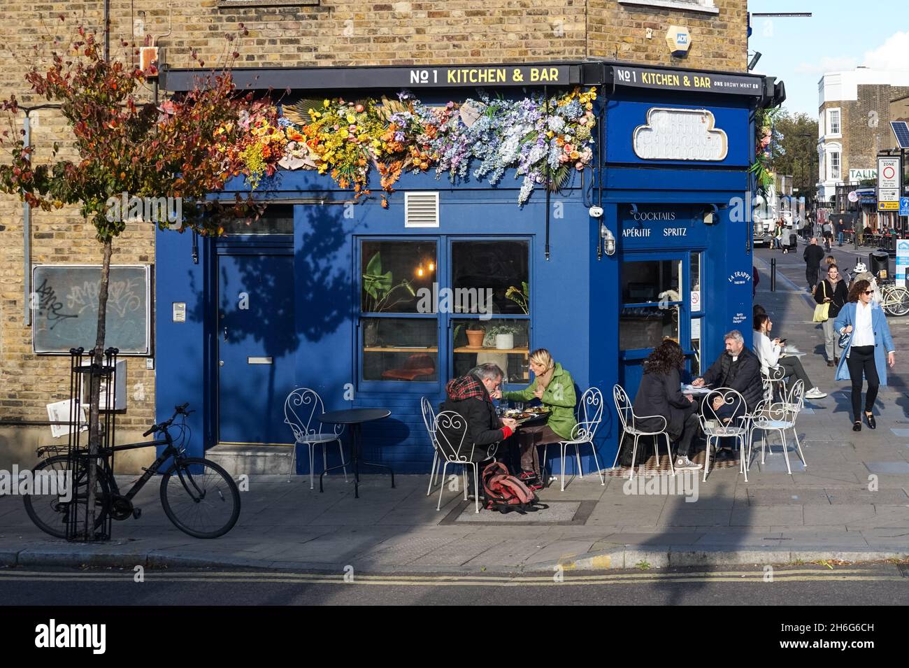 People sitting outside restaurant on Broadway Market in Hackney, London England United Kingdom UK Stock Photo