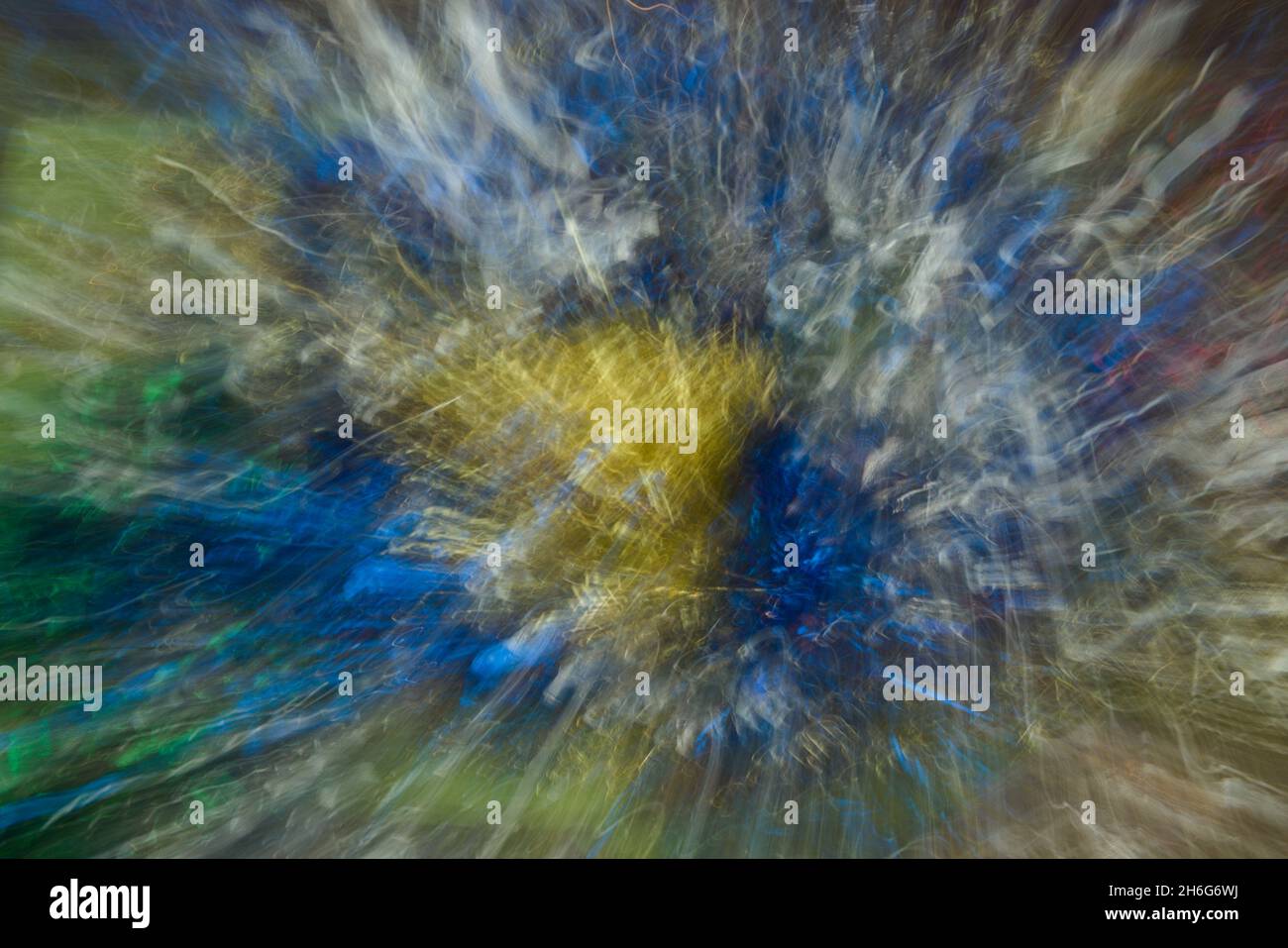 Bursting  colors, abstract of metallic  patterns, lines of blues, yellows, reds, golds, green was created by zooming & twisting camera. Color fusion. Stock Photo