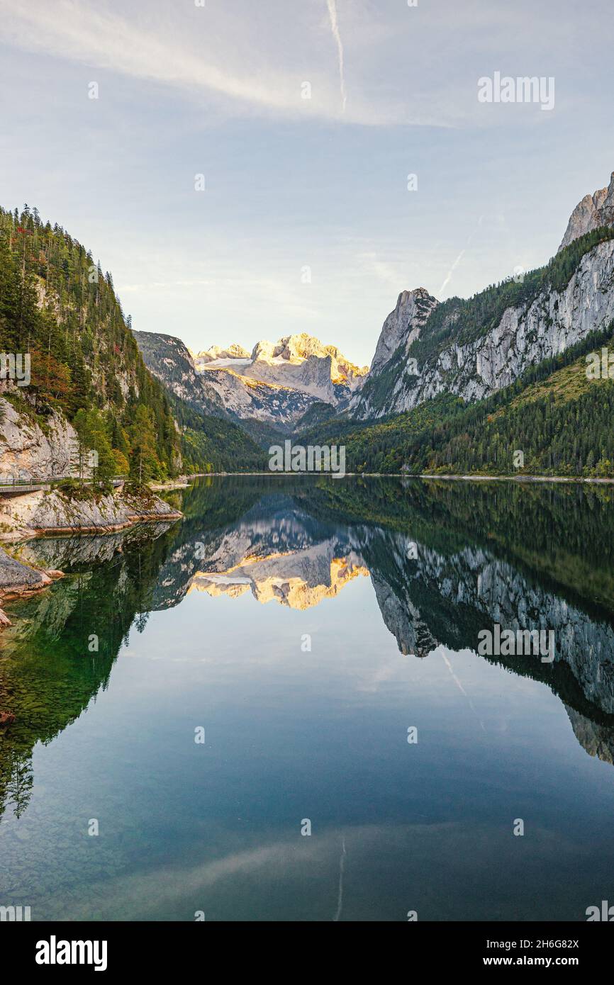 Beautiful view of idyllic colorful autumn scenery with Dachstein mountain summit reflecting in crystal clear Gosausee mountain lake in fall Stock Photo
