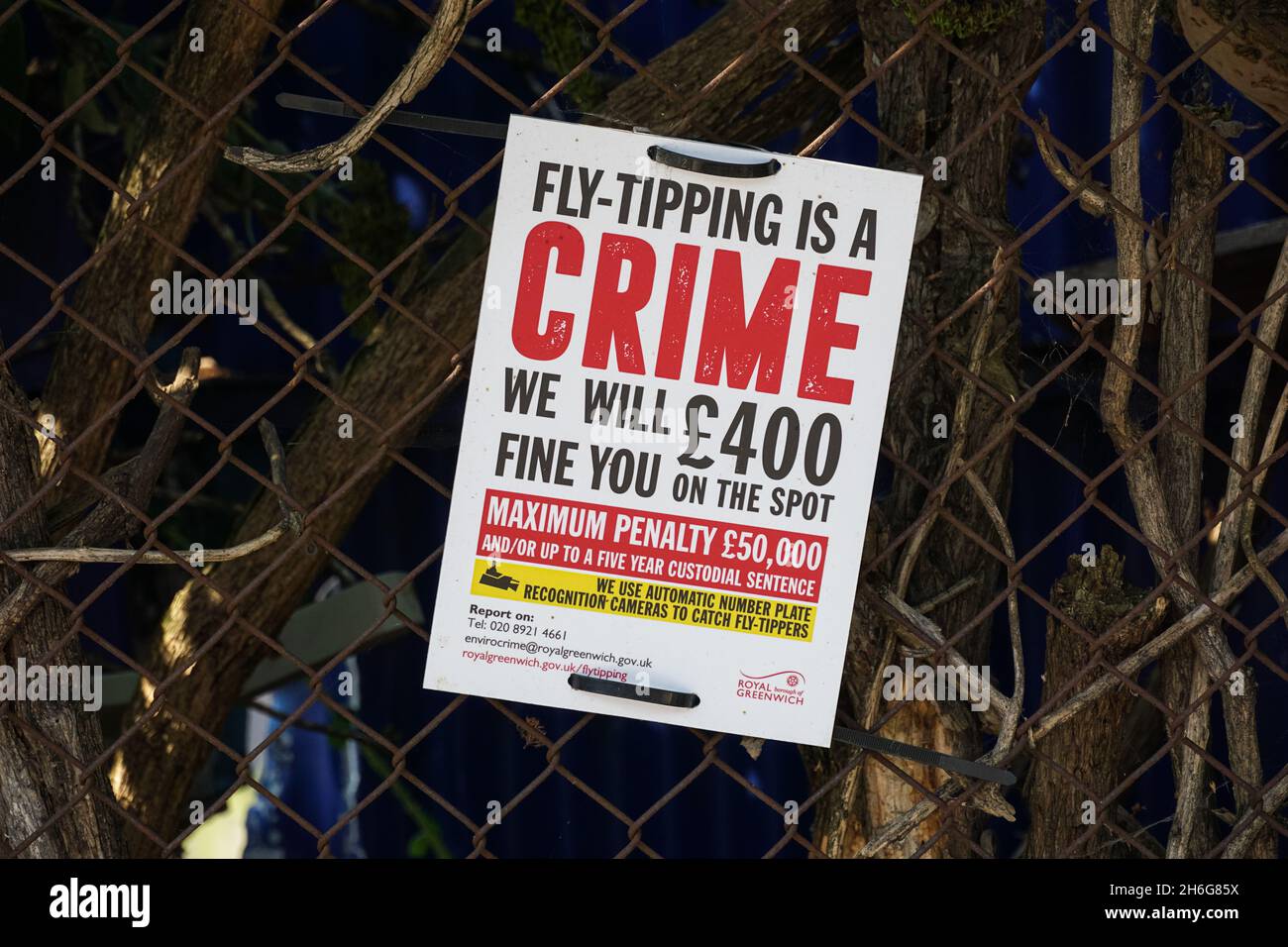 Fly tipping warning sign on a fence in London England United Kingdom UK Stock Photo
