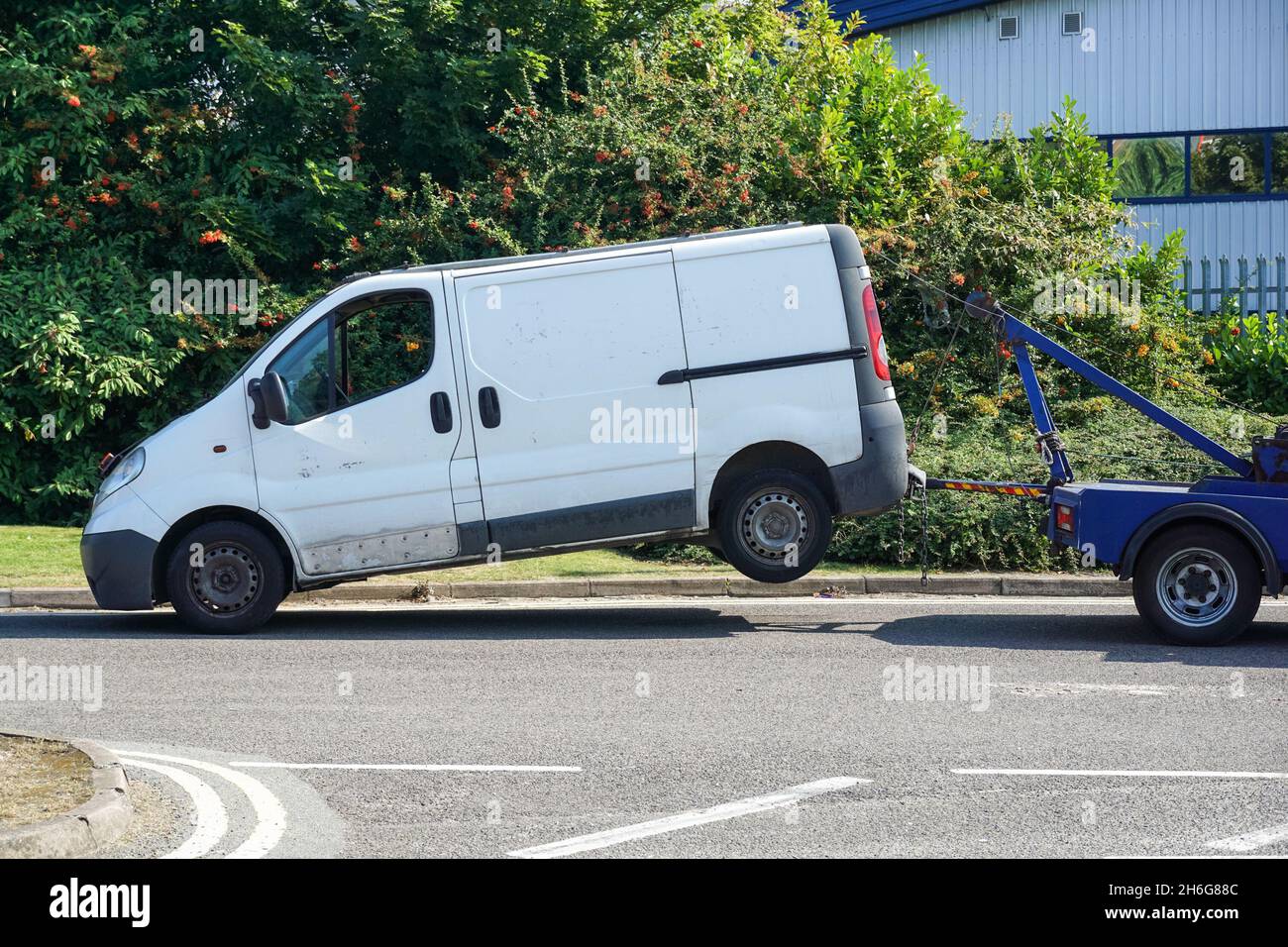 A wheel-lift tow truck with broken van in London England United Kingdom UK Stock Photo