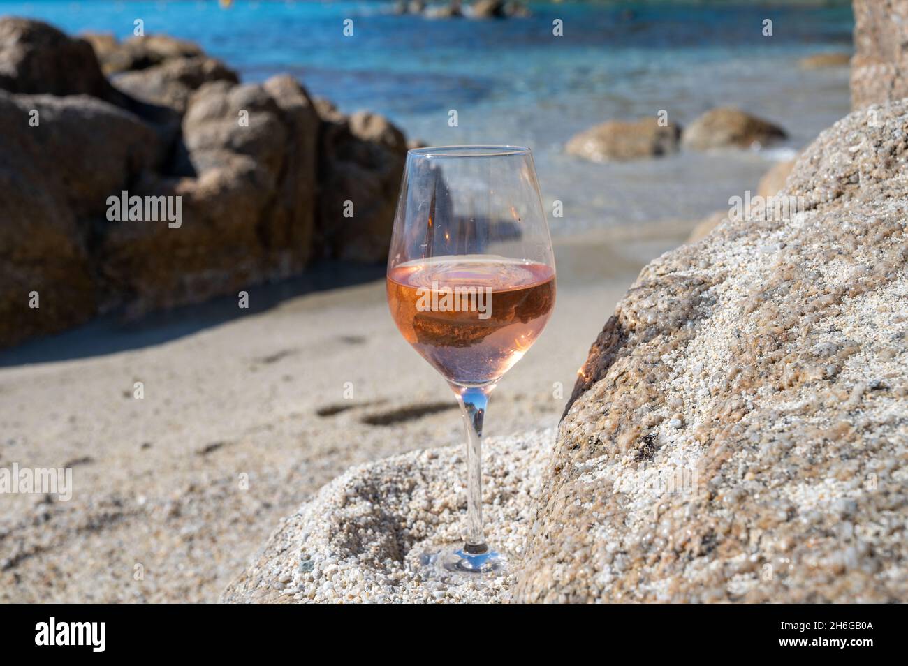 Summer time in Provence, glass of cold rose wine on sandy beach near Saint-Tropez in sunny day, Var department, France Stock Photo