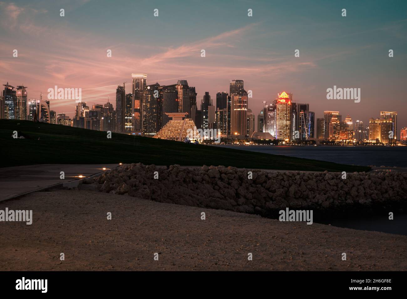 Doha Qatar skyline at night from Museum of Islamic art garden showing skyscrapers lights
