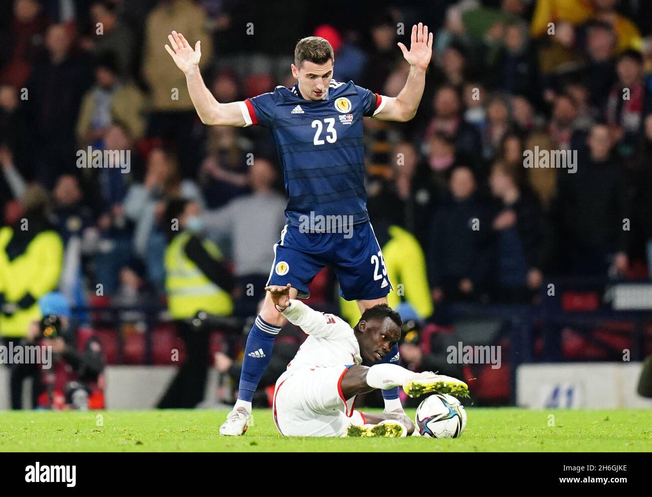Scotland's Kenny McLean (left) and Denmark's Pione Sisto battle for the ball during the FIFA World Cup Qualifying match at Hampden Park, Glasgow. Picture date: Monday November 15, 2021. Stock Photo