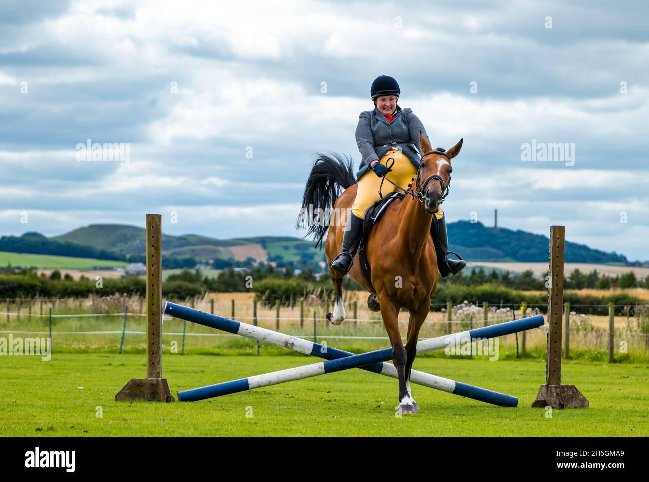 Summer horse show with a horse jumping over a horse jump, East Lothian, Scotland, UK Stock Photo