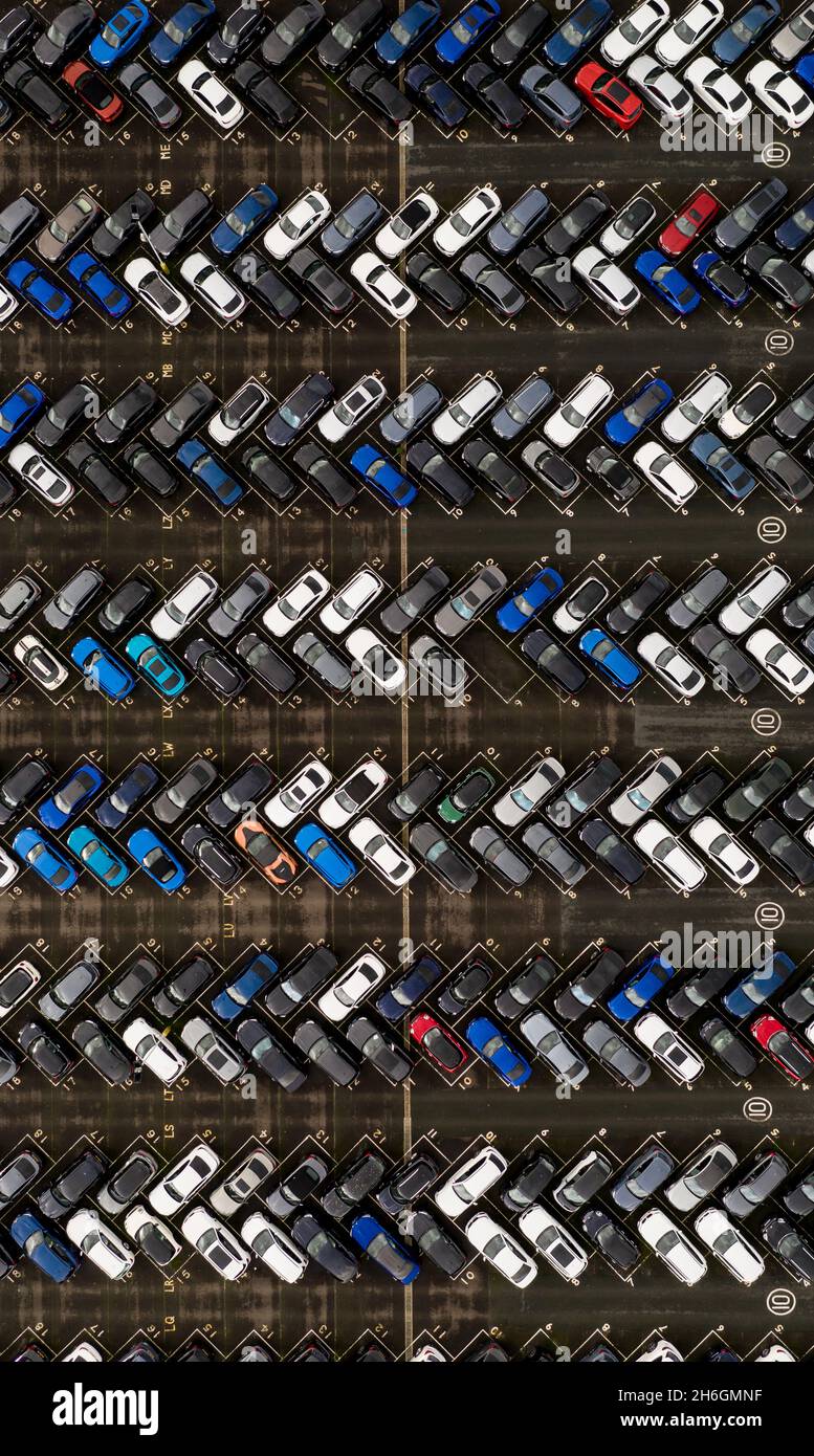 An aerial view directly above a new car manufacturer's stockpile of