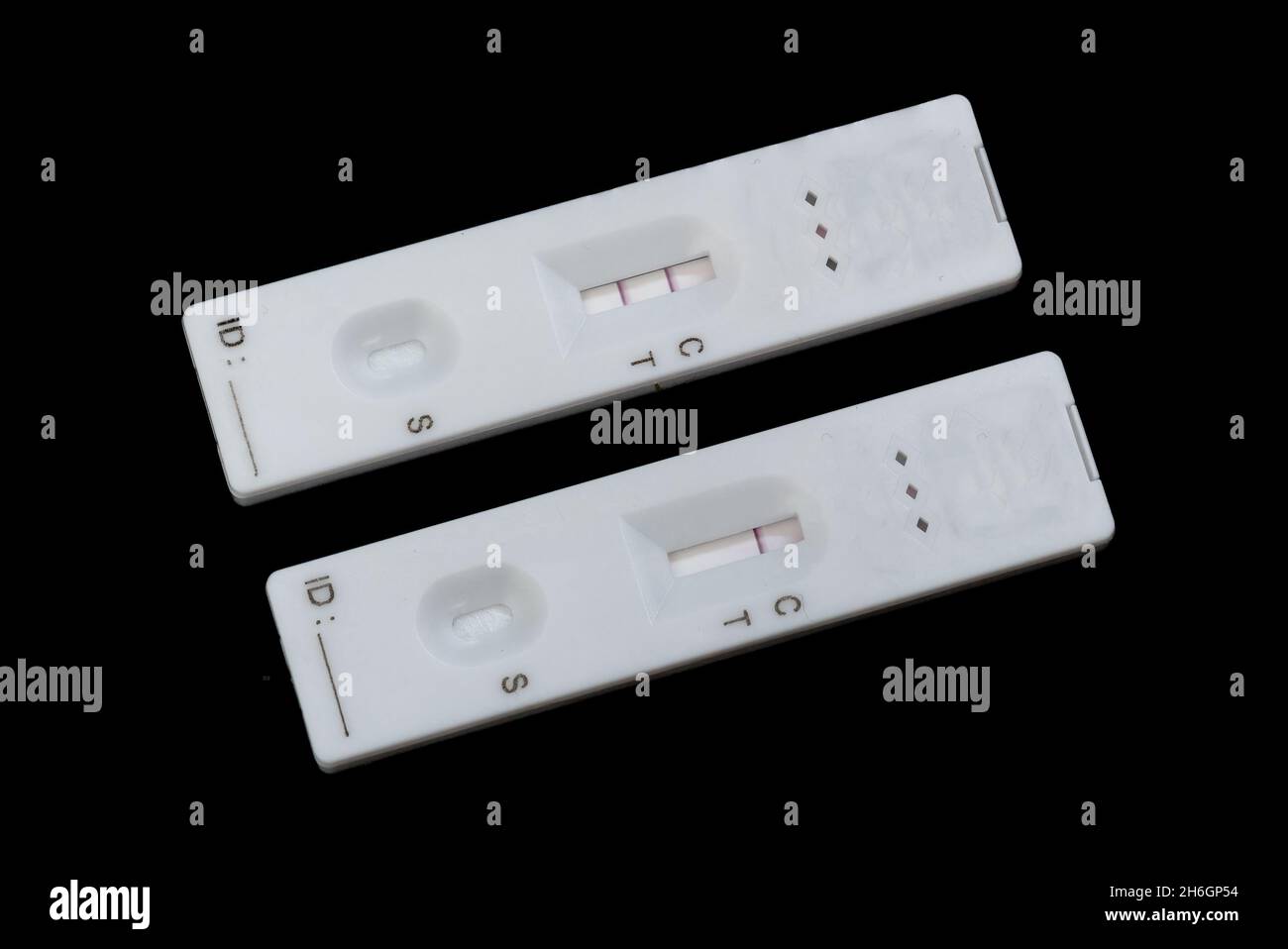 Two Covid19 Rapid Lateral Flow Tests, one showing a negative result