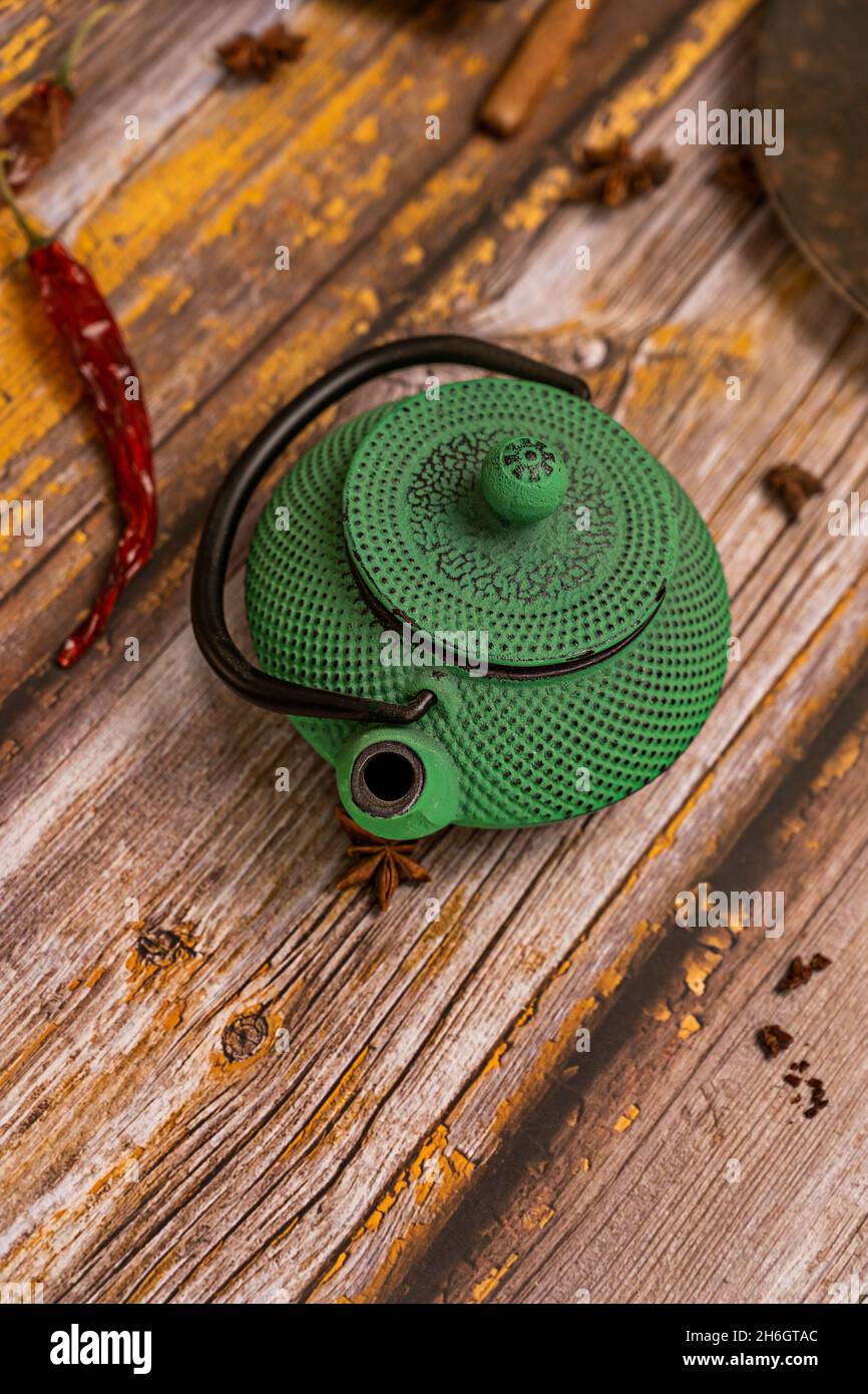 traditional green wrought iron teapot to serve tea in asia Stock Photo
